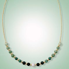 This dainty necklace is expertly crafted with beautiful jade beads of varying green shades and one delicate lavender jade focal bead in the center. The result is a stunning piece that exudes elegance and captures the eye. Mint, green, black and lavender jade (6mm) Length: 18" SELECT METAL Green Jade Jewelry For Meditation, Elegant Green Crystal Necklace With Natural Stones, Elegant Green Necklaces With Natural Stones, Elegant Jade Necklace For Healing, Elegant Green Necklace With Natural Stones, Elegant Green Jade Crystal Necklace, Green Jade Spiritual Necklace, Spiritual Green Jade Necklace, Elegant Jade Crystal Necklaces With Round Beads