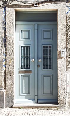 the front door is painted blue and has bars on each side to give it an interesting look