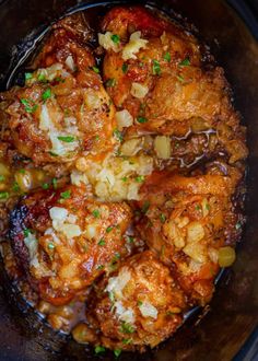 meatballs and potatoes in a slow cooker with parmesan cheese on top