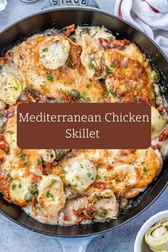 a skillet filled with chicken, pasta and sauce on top of a white table