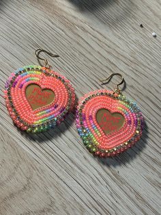 Beaded Mama Bear earrings made with neon colors Heart-shaped Multicolor Beaded Earrings, Handmade Neon Jewelry For The Beach, Fun Rainbow Beaded Earrings, Handmade Rainbow Beaded Earrings For Party, Trendy Rainbow Round Bead Earrings, Multicolor Heart-shaped Beaded Earrings, Rainbow Party Earrings With Colorful Beads, Vibrant Beaded Earrings As A Gift, Vibrant Beaded Earrings For Gifts