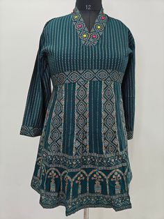 Short Kurta For Women/ Tunic Dresses - T-shirt For Women / Cotton Kurti Embroidery Tunic Kurta / Indian Short Kurti / Ethnic Kurti For Women Product Description Teal Green  Embroidery  Printed  Tunic Kurta Neck Type : V Neck 3/4 Sleeves Easy to Carry In Summer Material and Care Viscose Rayon Cotton Hand wash, Machine wash Items includes One piece Kurta Note:- Please see the size chart in the image to choose a perfect size. Please feel free to ask any questions regarding this item WE ALSO ACCEPT CUSTOMISATION AS PER CUSTOMER REQUESTS. Green Embroidered Long Sleeve Tops, Traditional Crew Neck Top For Festivals, Green Printed Crew Neck Blouse, Green Embroidered Crew Neck Blouse, Blue Short Sleeve Tops For Festivals, Traditional Short Sleeve Festive Tops, Multicolor Long Sleeve Tops With Printed Motifs, Casual Festive Tops With Multicolor Embroidery, Festive Casual Tops With Multicolor Embroidery