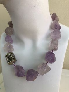 Amethyst Bold Necklace, hand-knotted in violet silk thread, 20 mm  natural rough, light amethyst stone, 6 mm rock crystal, 3 mm Swarovski crystal, antique African bead with sterling silver findings and toggle. This oneoff necklace is 19 inches in length, weight is 5.6 oz, handcrafted in North Palm Beach, Florida by designer artist Christine Smith. Watermelon Tourmaline Necklace, Gem Jewelry, Necklace Amethyst, Bold Necklace, Light Amethyst, Amethyst Jewelry, African Beads, Special Jewelry, How To Make Necklaces