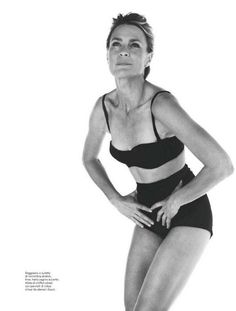 a black and white photo of a woman in a bathing suit with her hands on her hips