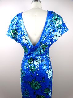 "This is a fully embellished vintage dress covered in bright blue and green sequins. The material is 96% cotton and 4% spandex, so there's is a little stretch in the material. It's in perfect condition! Measurements are taken not stretched and stretched: Size MEDIUM Measurements: Bust - 36-40\" Waist - 28-32\" Hips - 36-40\" Length - 43\" Size XL Measurements: Bust - 40-44\" Waist - 32-36\" Hips - 40-44\" Length - 43\" This dress comes from a pet-free and smoke-free home. If you would like more Blue Glamorous Sequin Summer Dress, Blue Glamorous Sequin Dress For Summer, Fitted Green Sequin Dress With Contrast Sequins, Fitted Blue Dress With Contrast Sequin, Fitted Green Sequin Dress With Contrast, Fitted Green Dress With Contrast Sequin, Blue Embellished Sequin Summer Dress, Blue Embellished Sequin Dress For Summer, Blue V-neck Embellished Sequin Dress