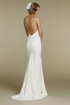 a woman in a white wedding dress looking back