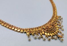 "22 k solid gold and pearl beads necklace choker from rajasthan india. detailed handcrafted, great piece for any collection. total length-15\"(we can adjust length), width of center-2.4 cm(inc. dangles), weight-17 grams. material-solid 22 k gold." Gold Kundan Pearl Necklace, Gold Chandbali Pearl Necklace For Puja, Gold Round Pearl Necklace For Festivals, Gold Plated Pearl Necklace In Temple Jewelry Style, Gold Chandbali Pearl Necklace In Temple Jewelry Style, Gold Chandbali Pearl Necklace In Temple Style, Gold Pearl Necklace With Latkans Temple Style, Gold Pearl Necklace With Intricate Design For Diwali, Gold Pearl Necklace With Meenakari For Festive Occasions