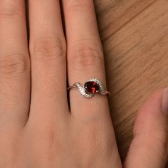 It is a natural garnet ring. The main stone is 5mm*7mm oval cut, weight about 1.06 carats. The basic metal is sterling silver and plated with rhodium. To change the metal to a solid gold (white/rose) or platinum is also available, please ask for a quotation if you want. You can also go to my shop Home for more elegant rings: https://www.etsy.com/shop/godjewelry?ref=hdr_shop_menu More garnet rings: https://www.etsy.com/shop/godjewelry?ref=seller-platform-mcnav&section_id=20709242 Customizatio Silver Garnet Ring For Valentine's Day, Silver Garnet Birthstone Ring For Promise, Silver Oval Garnet Birthstone Ring, Oval Garnet Birthstone Ring In Silver, Oval Silver Garnet Birthstone Ring, Oval Garnet Birthstone Ring As Gift, Oval Garnet Birthstone Ring For Anniversary, Sterling Silver Oval Rings For Valentine's Day, Dainty Oval Red Ruby Ring