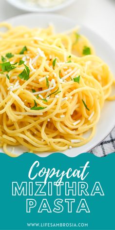 spaghetti with parmesan cheese and herbs on a white plate