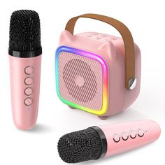 two microphones are next to a pink speaker