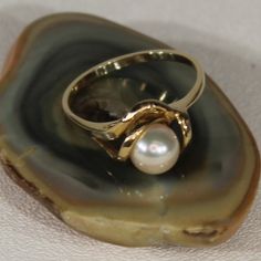 This Stunning Ring Is Crafted From 14k Yellow Gold And Features A 6.8mm Pearl In The Center. 14k Yellow Gold Pearl Ring - Size 6 2.1 Grams Pearl = 6.8mm 14k Yellow Gold High Luster Pearl Ring, Luxury Hallmarked Yellow Gold Pearl Ring, Luxury 14k Gold Hallmarked Pearl Ring, Luxury Adjustable Gold Pearl Ring, Luxury Yellow Gold Pearl Ring With Polished Finish, Gold Pearl Ring, 6 Rings, Gold Pearl, Pearl Ring