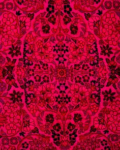 a red and black rug with an intricate design