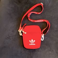 Great Versatile Nwot Red Fabric Adidas Crossbodyfanny Pack W Detachable Strap. 1 Outside Zipper Pocket1 Outside Slip Pocket1 Inside Zip Slip Pocket. Approximately 7” In Length5” Wide Easy Zipper Opening/Closing. White Accents. Noticed A Small Mark On Side Of Bag Near Zipper. See Last Picture. It’s Really Not Noticeable. Thanks So Much For Looking & Bid With Confidence Casual Red Shoulder Bag With Mobile Phone Holder, Red Functional Mobile Phone Bag, Casual Red Bag With Cell Phone Pocket, Trendy Red Nylon Shoulder Bag, Sporty Red Bag For Streetwear, Red Nylon Bag With Pockets, Red Nylon Bags With Pockets, Casual Red Nylon Shoulder Bag, Adidas Belt Bag