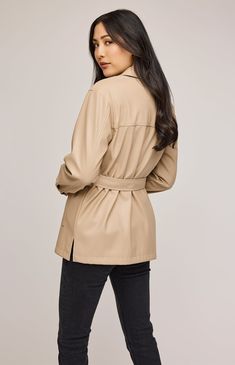 The Grenadine jacket is made of a soft faux leatherette and is fully lined for ease of wear. Features include patch pockets, side slits, and a removable belt for styling versatility. Sleek Fall Outerwear With Pockets, Chic Leather Outerwear With Pockets, Sleek Leather Belted Outerwear, Belted Long Faux Leather Coat, Belted Faux Leather Long Coat, Chic Beige Outerwear With Flap Pockets, Sleek Belted Fall Outerwear, Chic Leather Jacket With Belted Cuffs, Chic Beige Blazer With Flap Pockets