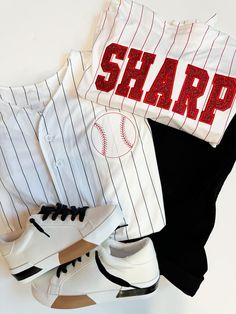 Stand out at the game with our Custom Pinstripe Baseball Jersey. This jersey features intricate embroidery and glitter applique, making it truly one-of-a-kind. Show off your unique style and personality with this playful and fun addition to your baseball gear. (And impress your teams, too!) Pricing includes one name on the back and one number, additional customization can be added, please ask for details on pricing! PLEASE NOTE the name and number, as well as glitter color in the notes! Product Details Feature: Pad print label Set-in sleeves Full-button jersey Double-needle hemmed sleeves and fishtail bottom. Sizing - See attached photo Fabric : 100% polyester smooth pinstripe knit / Wicks moisture away from the body Fit - Classic unisex fit Made to order: one week ship time Varsity Striped Baseball Jersey With Baseball Collar, Striped Varsity Baseball Jersey With Baseball Collar, Sporty T-shirt With Embroidered Graphics For Game Day, Game Day Striped Baseball Jersey With Letter Print, Striped Baseball Jersey With Letter Print For Game Day, Varsity Cotton Baseball Jersey With Three Stripes, Sporty Baseball Jersey With Contrast Stripes, Striped Cotton Baseball Jersey For College, White Tops With Letter Embroidery For Sports Season