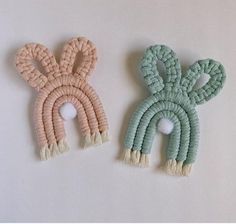 two knitted bunnies are sitting next to each other