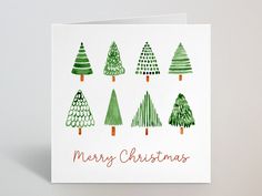 a christmas card with green trees on it