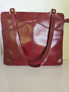 Gorgeous vibrant burgundy leather shoulder bag. The color on this bag is amazing.  The quality is awesome very little wear if any. Check this bag out on my YouTube channel at  Bag Size 11 inches wide by 10 1/2 inches tall, 9 1/2 inch strap drop. 8/10 Condition Formal Burgundy Shoulder Bag With Adjustable Strap, Burgundy Leather Crossbody Shoulder Bag, Burgundy Tote Satchel For Office, Burgundy Crossbody Shoulder Bag For Office, Burgundy Leather Lining Crossbody Shoulder Bag, Burgundy Office Tote Satchel, Office Shoulder Bag In Burgundy, Burgundy Leather-lined Crossbody Shoulder Bag, Formal Burgundy Crossbody Satchel