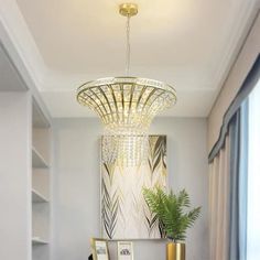 a living room filled with furniture and a chandelier hanging over the top of it