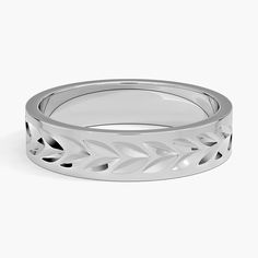 a white gold wedding band with leaves on it