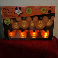 the mickey mouse pumpkins are lit up for halloween