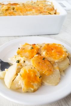 a white plate topped with potatoes next to a casserole dish