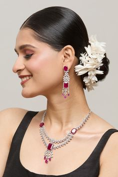 Silver plated double layer necklace embellished by white stone studded floral motifs highlighted by red ruby detail. Comes with matching earrings. - Aza Fashions Festive Wedding Jewelry With Gemstone Accents, Traditional Jewelry With Gemstone Accents For Party, Elegant Ruby Jewelry Sets With Matching Earrings, Elegant Ruby Jeweled Jewelry Sets, Red Jewelry With Gemstone Accents For Party, Red Gemstone Accented Jewelry For Party, Red Gemstone Accent Jewelry For Party, Red Party Jewelry With Gemstone Accents, Elegant Ruby Jewelry Sets For Party