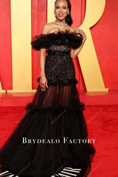 Kerry Washington dazzled at the 2024 Oscars After Party in a striking black gown with a sheer tulle skirt that cascades to the floor. The off-the-shoulder design features a ruffled neckline, and the bodice is adorned with sparkling embellishments, cinched at the waist with a satin bow, adding both elegance and drama. shown color: black with build-in-bra with boning back zipper closure partially lined Evening Off-shoulder Tulle Gown, Glamorous Off-shoulder Gown With Ruffles, Off-shoulder Tulle Evening Dress, Black Ruffled Gown For Prom Season, Black Ruffle Gown For Prom Season, Off-shoulder Tulle Evening Dress For Party, Black Strapless Tulle Evening Dress, Off-shoulder Tulle Gown For Party, Off-shoulder Organza Party Gown