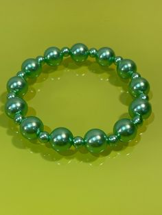 Introducing our vibrant Summer Green Bead Bracelet jewellery, a charming accessory handcrafted with love. This exquisite piece is designed with 12mm and 6mm resin beads, strung together on a durable doubled elastic cord, ensuring a comfortable fit for wrists sized between 6.5 - 7.5 inches or 16.5 - 18.5 cm. Priced at just £4.50 each, it's the perfect gift for any occasion, whether birthdays, celebrations, or just because it's a thoughtful gift for her. You can make someone smile today with this Cheap Green Novelty Bracelets, Make Someone Smile Today, Green Beaded Bracelets, Thoughtful Gifts For Her, Summer Green, Resin Beads, May 7, Green Bead, Adjustable Bracelet