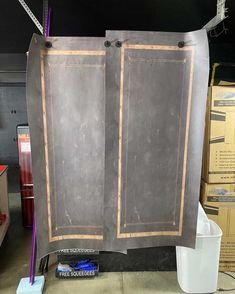 a large metal cabinet with two doors on it's sides and some tools next to it