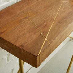 a close up of a wooden table with metal legs