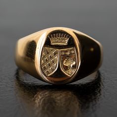 A regal engraving of two crests beneath a crown adorns the signet of this unique vintage ring. Substantial and prestigious, this ring feels both historic and fashion-forward. The thick band tapers in the back for an everyday comfortable fit. Metal: 18k Yellow GoldMeasurements: Width: 12-2mm Size 6.25 in stock Shipping and Delivery: IN STOCK items will ship within 2 business days Sizes not In Stock will be Resized Resize Fee may apply Please allow 2 weeks for delivery All Resize items are final s Classic Hallmarked Signet Ring For Collectors, Classic Hallmarked Signet Ring Collectible, Classic Ceremonial Signet Ring With Polished Finish, Classic Engraved Signet Ring For Ceremonial Occasions, Classic Engraved Signet Ring For Ceremonial Use, Victorian Oval Signet Ring With Polished Finish, Classic Engraved Ceremonial Signet Ring, Classic 14k Gold Signet Ring For Ceremonial Occasions, Classic Oval Ceremonial Signet Ring