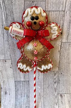 a candy cane with a teddy bear on it