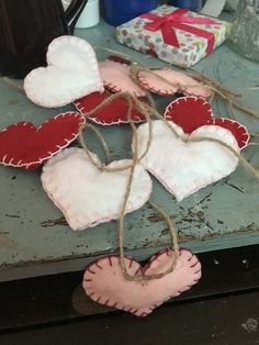 two hearts hanging from twine on top of a table