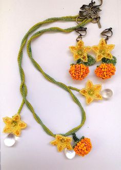 My first design for Halloween for this year! A whimsical pair of earrings and an ethereal necklace to match, inspired by the pumpkin patches that we all love! Elegant pumpkin blossoms, plump pumpkins, and vines, ready to be worn during your autumn promenades!  They are entirely made by hand with premium quality miyuki and duo glass beads, fireline thread, and the hooks of your preference. Whimsical Handmade Beaded Dangle Necklaces, Cute Handmade Orange Jewelry, Cute Orange Handmade Jewelry, Handmade Fairycore Beaded Necklaces, Cute Orange Beaded Jewelry, Pumpkin Blossoms, Ethereal Necklace, Earrings Fairycore, Beaded Pumpkin