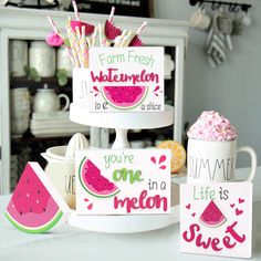 watermelon cupcakes and other treats are displayed on a cake stand in a kitchen