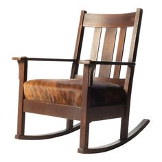 a wooden rocking chair with leather seat and armrests on an isolated white background