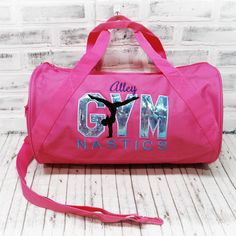 "GYMNASTICS! With a silvery purple applique GYM-nastics wording, this tote is ready to hold all your stuff whether for after school dance practice, competitions or even a weekend at grandma's! Add a name for a super personalized bag.   SEE PHOTOS FOR SIZE CHARTS AND POLICIES  ABOUT THIS BAG: 🐉 Choose from a large duffel - 24\", small duffel - 18\", or 12x18\" zipper top tote. 🐉 Embroidered on a denier polyester bag- Made with 50% recycled material. Small bag has a single zippered main compartm Purple Applique, Gymnastics Bags, Pink Duffle Bag, Small Luggage, Girls Personalized Gifts, School Dance, Go Bags, Turquoise And Purple, Zipper Tote Bag