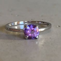 "A TINY round-shape faceted genuine Purple Amethyst hand set in a 4-prong setting featuring a tapered sterling silver shank. This beauty makes a great birthstone ring for those February Birthday gals or a lovely stackable ring for her! Wrapped in a box ready for gift-giving. (r-egt-146) Ring info ------------------------- Genuine Purple Amethyst measures 5mm Sterling Silver *Follow us @belesasjewelry on Instagram for promotions/giveaways *LIKE* us on Facebook http://www.facebook.com/Belesas to f Classic Amethyst Round Cut Birthstone Ring, Classic Amethyst Birthstone Ring With Round Cut, Modern Crystal Ring With Prong Setting, Fine Jewelry Amethyst Birthstone Ring, Round Cut, Fine Jewelry Amethyst Birthstone Ring Round Cut, Amethyst Solitaire Crystal Ring In Fine Jewelry Style, Purple Topaz Promise Ring, Modern Ruby Birthstone Ring, Formal Amethyst Birthstone Ring With Round Stone