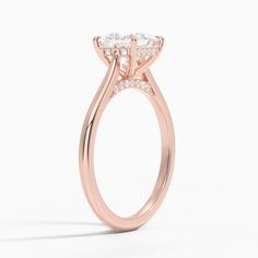 Princess Cut Dawn Diamond Engagement Ring - 14K Rose Gold. This stunning ring features a petite band that sweeps up to embrace the gemstone in delicate claw prongs. Diamond accents adorn the gallery wire and bridge adding a unique touch to a classic look (1/10 total carat weight). Formal 14k Rose Gold Ring With Prong Setting, Elegant 14k Rose Gold Ring With Center Stone, Elegant Oval 14k Rose Gold Ring, Classic Rose Gold Princess Cut Wedding Ring, Elegant 14k Rose Gold Diamond Promise Ring, Delicate Brilliant Cut Rose Gold Diamond Ring, Rose Gold Marquise Cut Diamond Ring With Single Diamond, Elegant 14k Rose Gold Jewelry With Prong Setting, Classic 14k Rose Gold Rings With Prong Setting