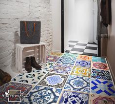 an entryway with colorful tiles on the floor