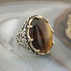 The ring is made of 925 sterling silver and adorned with Tiger eye stone. PRODUCT FEATURES -Products are shipped with free shipping with box and bag. - Crafting Material : 925K Sterling Silver - Weight : 18.0 grams - Gemstone Diameter : 18 x 25 mm - Gemstone :Tiger eye - Gender : Male / Female ✔ Ready to Ship in 1-3 Business Days ✔ Shipped to the worldwide 1-3 business days with free express shipping. ✔ The product will be sent to you with a box to avoid any damage during shipping. Digestive sys Elegant Brown Gemstone Signet Ring, Brown Gemstone Signet Ring, Brown Sterling Silver Signet Ring With Polished Finish, Luxury Brown Oval Rings, Silver Men Ring, Tiger Eye Gemstone, Brown Stone, Sterling Silver Mens Rings, Tigers Eye Gemstone