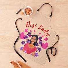 an apron with the words desi laga on it next to eggs and utensils