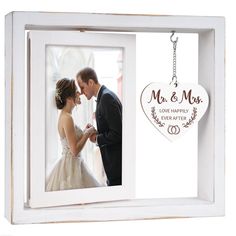 a wedding photo frame with a bride and groom holding each other's hand in front of a window