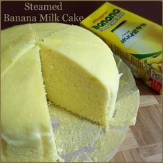 a sliced cake on a plate next to a box of banana milk