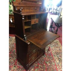 an old wooden desk with drawers on top