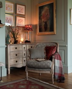 a living room filled with furniture and pictures on the wall