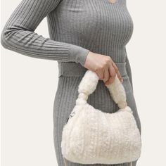 Discover Your New Fashion Favorite Step out in style with the Plush Faux Fur Hobo Handbag, a perfect blend of elegance and practicality. This handbag is not just an accessory; it's a statement piece that complements any outfit, whether you're on a casual day out or a special evening event. Its versatile design ensures it fits seamlessly into any wardrobe, making it ideal for all your fashion needs. Exceptional Features Material: Luxurious faux fur that's soft to the touch yet durable. Size: Compact yet spacious - 9.8x2.6x5.9", perfect for your essentials. Interior: Includes a handy cell phone pocket to keep your phone accessible. Multiple Carrying Options: Comes with a long shoulder strap and a short handle for varied styles. Closure: Secure zipper closure to keep your belongings safe. Sty Fall Handheld Hobo Bag, Elegant Winter Tote Shoulder Bag, Elegant Winter Tote Bag, Winter Shoulder Bag With Detachable Strap, Versatile Shoulder Bag For Winter, Elegant Winter Shoulder Bag For Shopping, Elegant Winter Shoulder Bag, Chic Bags For Daily Use In Winter, Chic Winter Bags For Daily Use