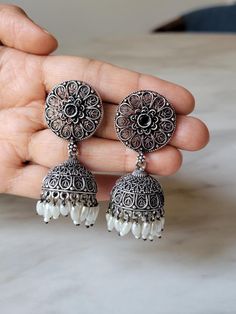 Indian earrings that can be paired with everything in your closet, from ethnic to casual to festive wear. This oxidized silver Indian earrings will add a dash of ethnic flair to your attire.  SAVE WITH MORE OFFERS: SPEND $35 and GET FREE SHIPPING SPEND $70 and GET 25% OFF. Coupon Code: DAMAK25 Materials & Specifications: Made from antique oxidized silver plated brass alloy.  QUESTIONS??? Feel free to message me! CARE INSTRUCTIONS: Please keep antique oxidized earrings away from harsh chemicals, perfumes and water to ensure its life. Store it in a cool, dark place, preferably in a separate jewelry box to prevent scratching, tangling, and breaking, and to maintain its shine for a long time. Traditional Earrings With Oxidized Finish And Adjustable, Traditional Earrings With Oxidized Finish, Traditional Oxidized Finish Earrings, Traditional Earrings With Bells, Bohemian Black Jhumkas For Gift, Bohemian Black Jhumkas As Gift, Elegant Heavy Jhumkas For Festival, Festive Beaded Drop Earrings, Elegant Festival Jhumkas