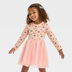 Your little one will love the magical charm of this Afro Unicorn Tulle Dress. This pullover dress features a long-sleeve jersey bodice in light pink with colorful Afro Unicorn graphics, stars and hearts. A flouncy knee-length mesh skirt in pretty pink completes the look with ballerina-worthy flair. April Showers is founder and CEO of Afro Unicorn, a brand designed to remind women and children of color how unique, divine and magical they truly are. Her goal from the beginning was to help normaliz Spring Party Tutu Dress With Long Sleeves, Long Sleeve Tutu Dress For Party, Pink Princess Long Sleeve Tutu Dress, Spring Party Long Sleeve Tutu Dress, Pink Long Sleeve Princess Tutu Dress, Cute Long Sleeve Tutu Dress For Party, Pink Long Sleeve Tutu Dress For Spring, Spring Long Sleeve Pink Tutu Dress, Cute Long Sleeve Pink Dress